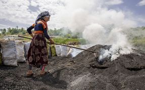 (Video) İşçilerin ateş karşısında mangal kömürü üretimi